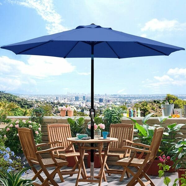 Dark blue umbrella on a table infront of a city