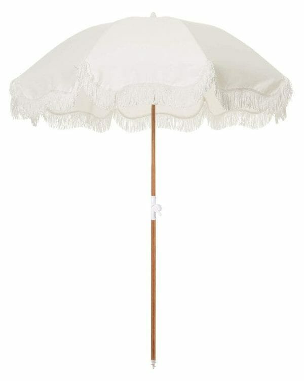 A 5.5 Ft Fringe Cotton Beach Umbrella with tassels on it.