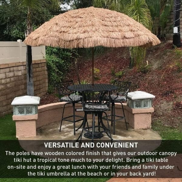 A table and chairs with an 8.5 Ft Thatched Beach Umbrella in the background.