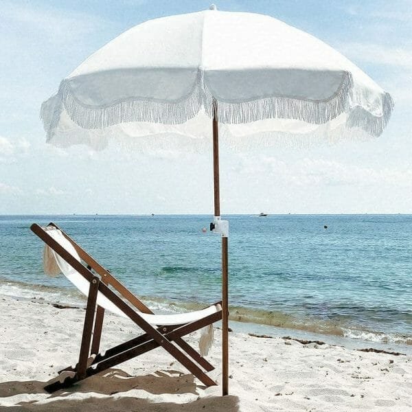 an umbrella sitting on top of a sandy beach