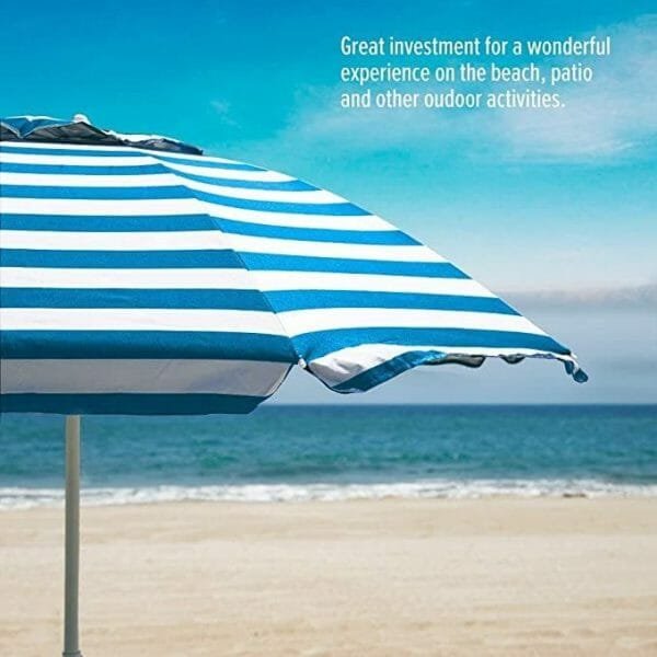 an umbrella sitting on top of a sandy beach