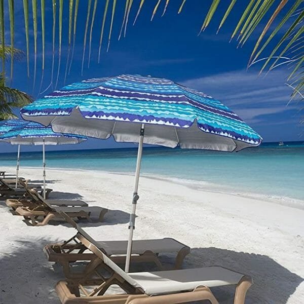 a group of lawn chairs sitting on top of a sandy beach