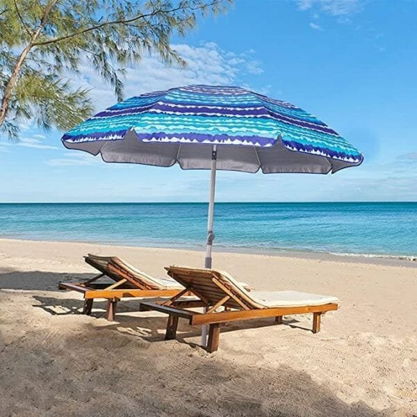 a couple of lawn chairs sitting on top of a beach