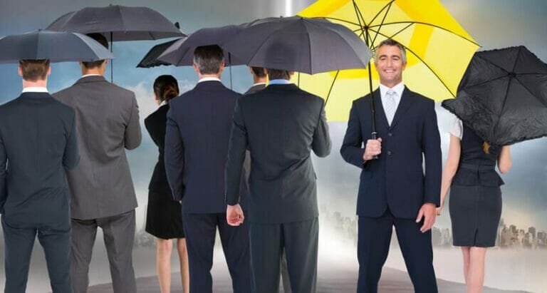 a group of people standing in the rain holding an umbrella