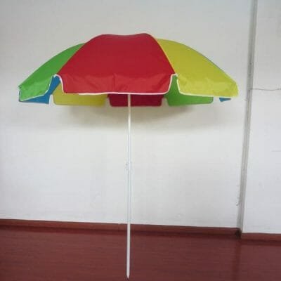 A 1.8M Polyester Beach Umbrella sitting on a wooden floor.