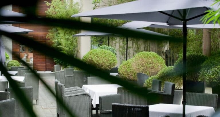 An outdoor dining area with tables and umbrellas.