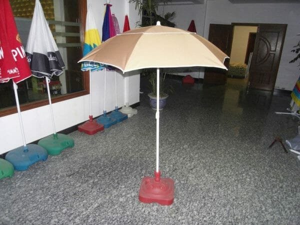 An 1.2M Polyester Beach Umbrella on a table in a room.