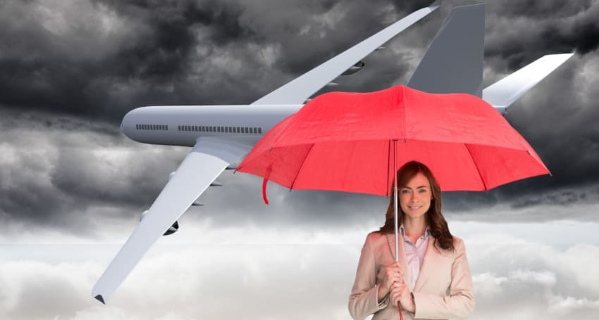 Woman with red umbrella in front of plane