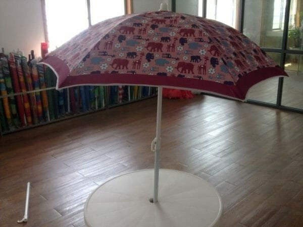 A 1.2M Polyester Beach Umbrella with a red and white pattern on it.