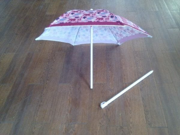 A 1.2M Polyester Beach Umbrella on a wooden floor.