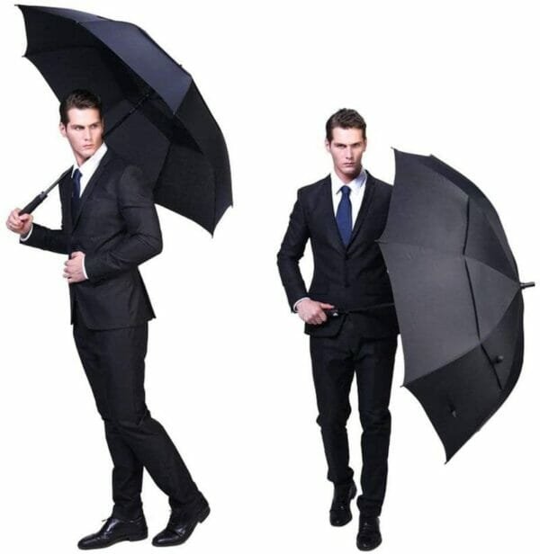 a person in a suit holding an umbrella