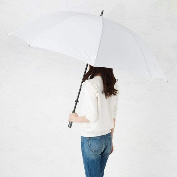 A woman holding a 30inch Cheap Golf Umbrella Pongee in front of a white wall.