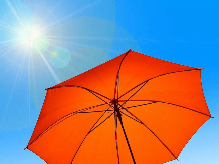 How much protection can umbrellas provide against the sun's harmful UV rays