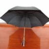 A 27in Aluminum Single Layer Auto Golf Umbrella sitting on a wooden floor.