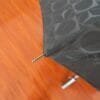 A 27in Aluminum Single Layer Auto Golf Umbrella on a wooden floor.