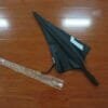 A 27inch Manual Open Golf Umbrella laying on a wooden floor.