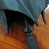 A 27inch Manual Open Golf Umbrella on a wooden floor.