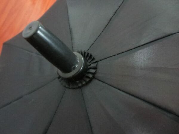 A 27inch Manual Open Golf Umbrella on a wooden floor.