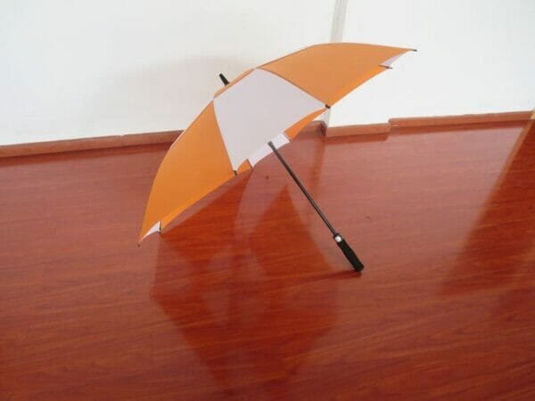 A 27inch Double Layer Golf Umbrella on a wooden floor.