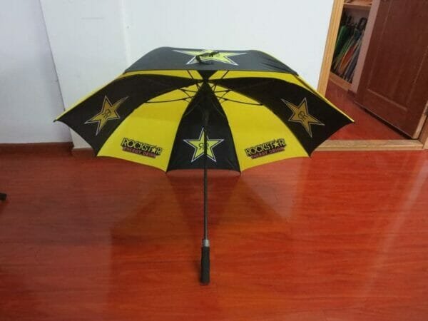 A yellow and black 30inch Double Layer Golf Umbrella 190T with stars on it.