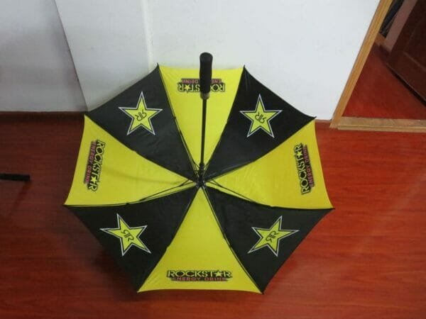 A yellow and black 30inch Double Layer Golf Umbrella 190T with stars on it.