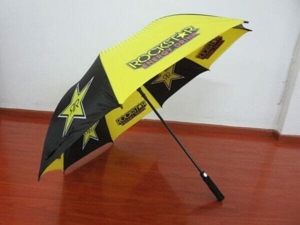 A yellow and black 30inch Double Layer Golf Umbrella 190T with stars on it.