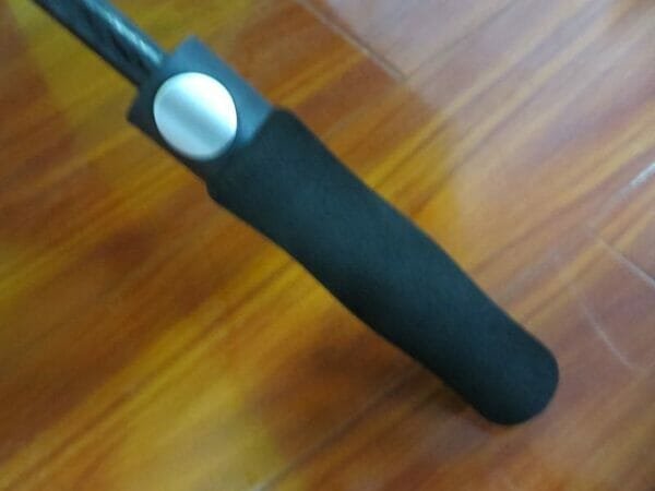 A black handle on a 30inch Double Layer Golf Umbrella 190T.