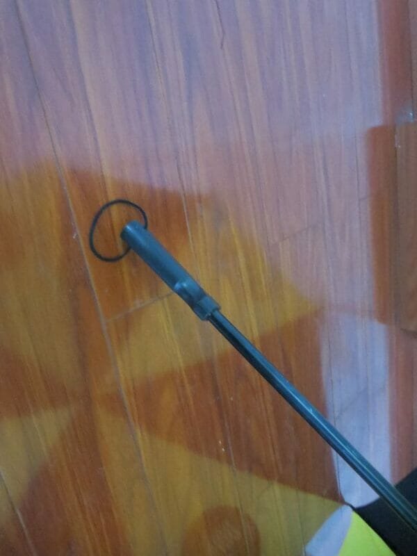A wooden floor with a 30inch Cheap Golf Umbrella sticking out of it.