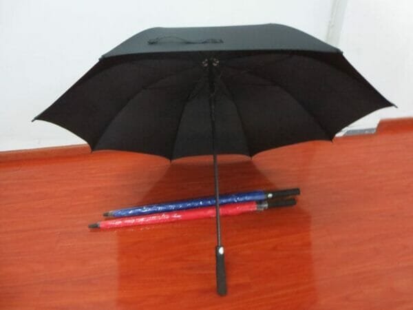 A 30in Single Layer Auto Golf Umbrella Plain on a wooden floor.