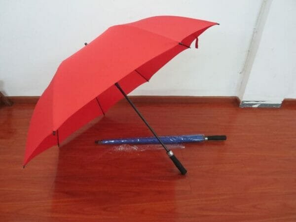 A 30in Single Layer Auto Golf Umbrella Plain sitting on a wooden floor.