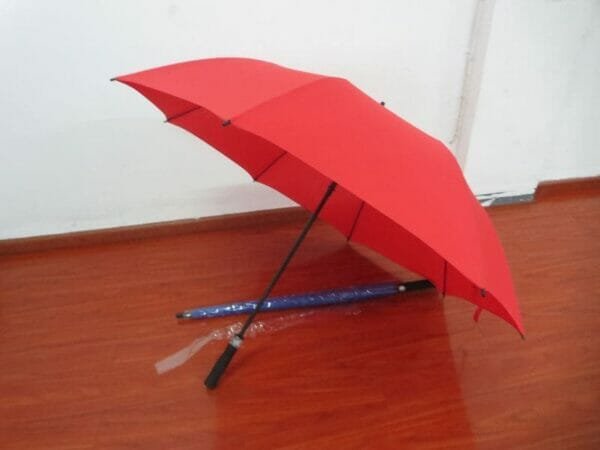 A 30in Single Layer Auto Golf Umbrella Plain sitting on a wooden floor.