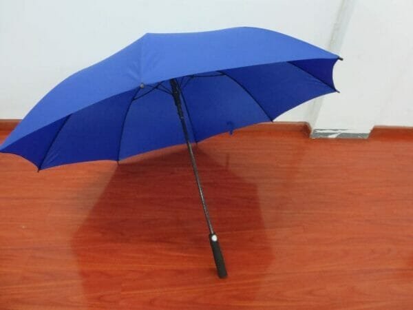 a large blue umbrella in the rain