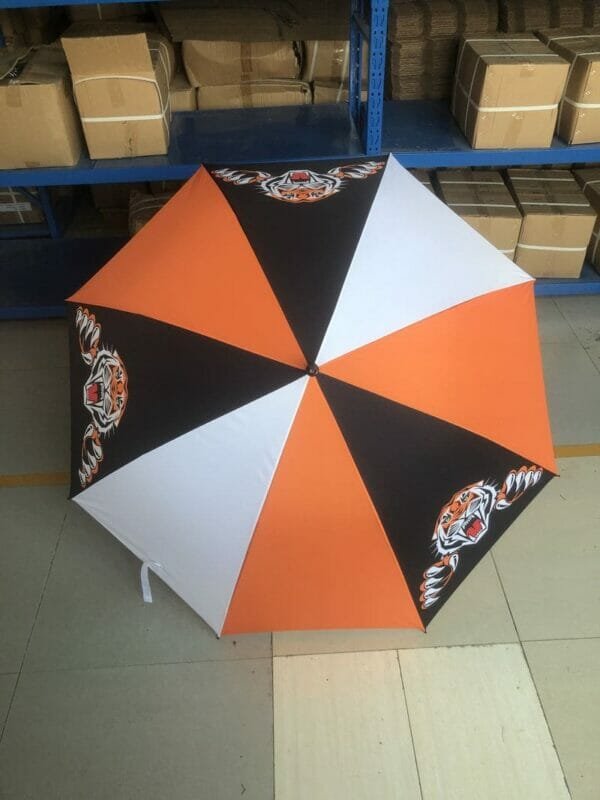 A 30in 280T Single Layer Auto Golf Umbrella sitting in a warehouse.