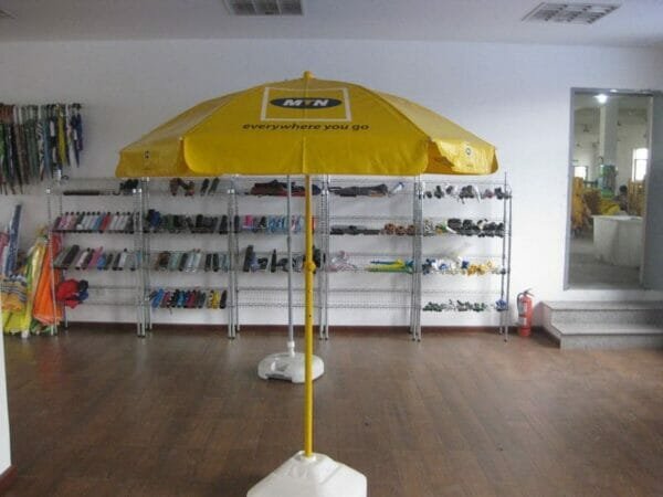 A 1.6m PVC Beach Umbrella sitting on a shelf in a room.