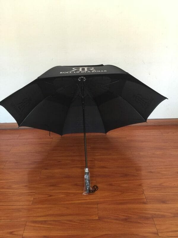 A Double Layer Golf Umbrella Rubber Handle | ARDECO sitting on a wooden floor.