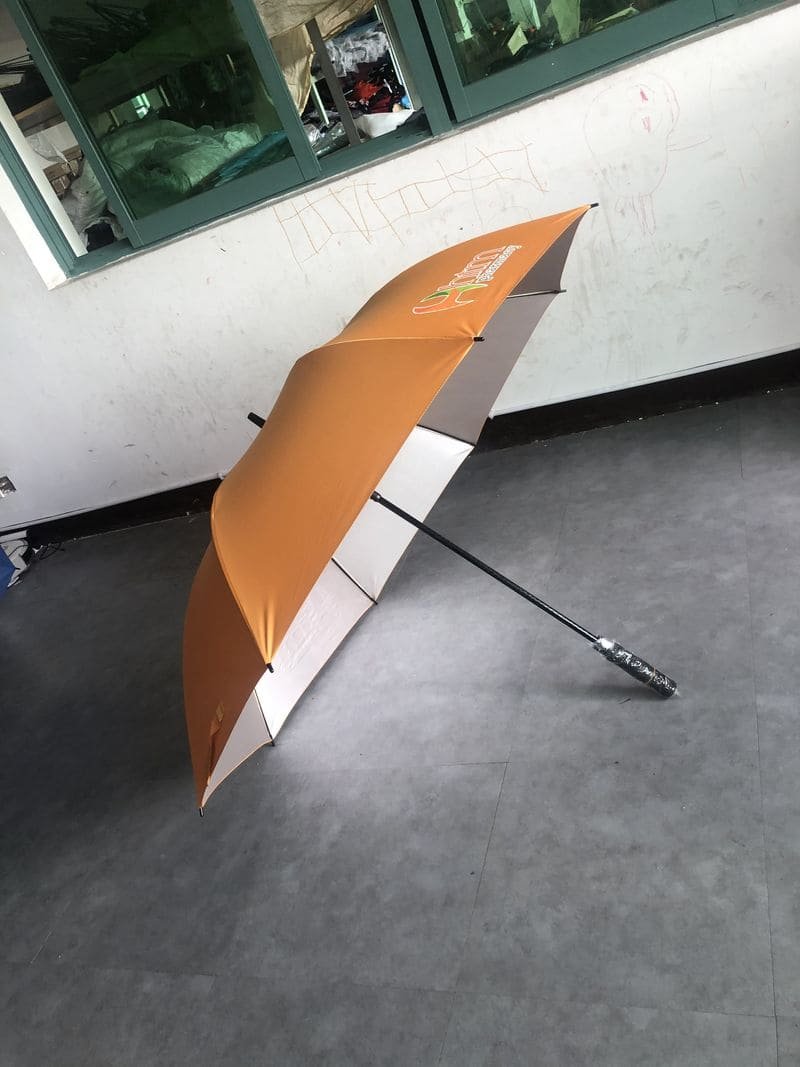 A 30in Single Layer Auto Golf Umbrella Silver UV sitting on a concrete floor.