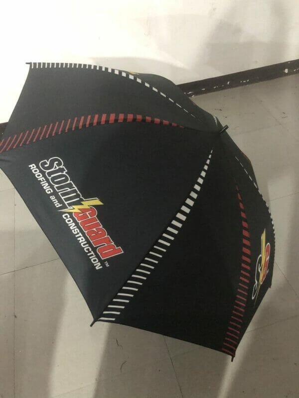 A 32in Single Layer Auto Golf Umbrella with red and black stripes on it.