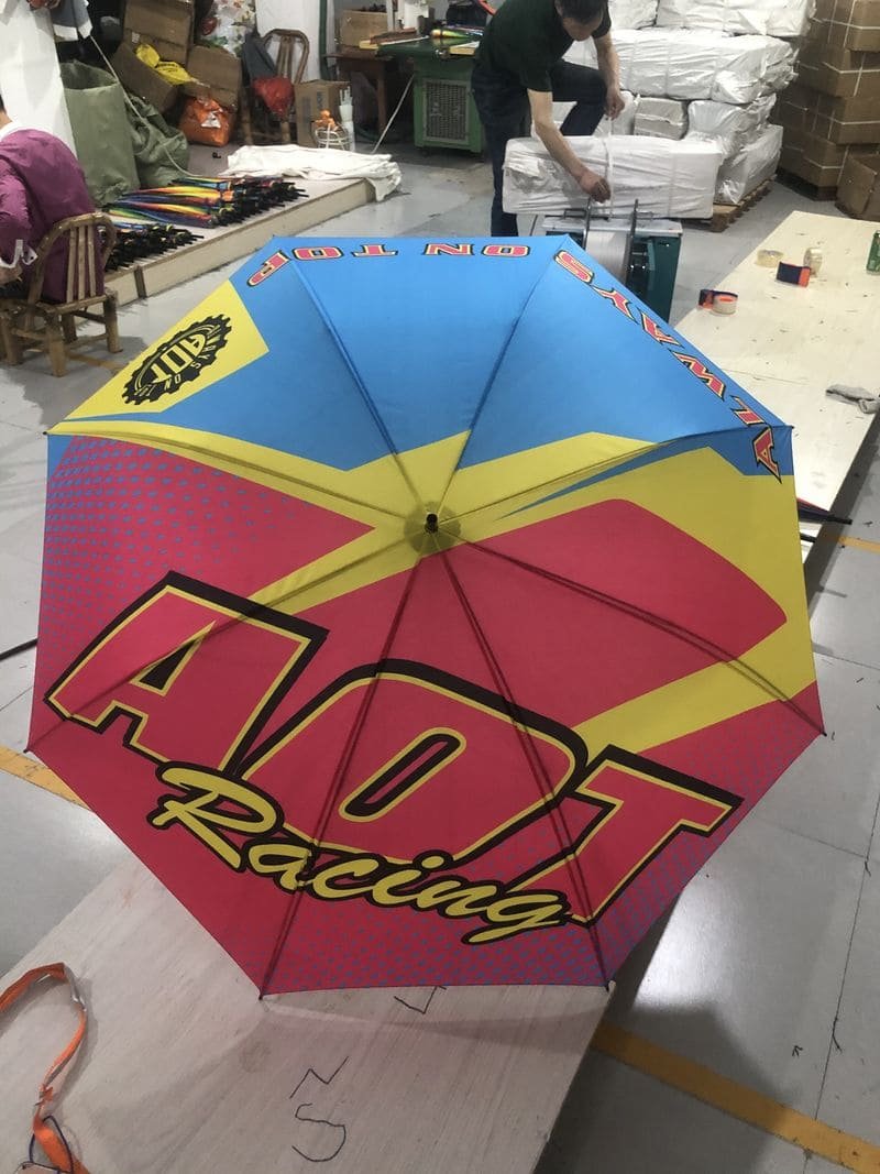 An umbrella with the word ARDECO racing on it.