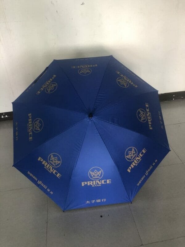 A 30in Black Single Layer Auto Golf umbrella with a gold logo on it.