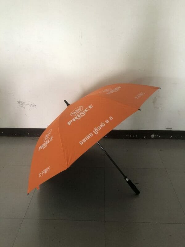 A 30in Black Single Layer Auto Golf Umbrella is sitting on the floor of a room.