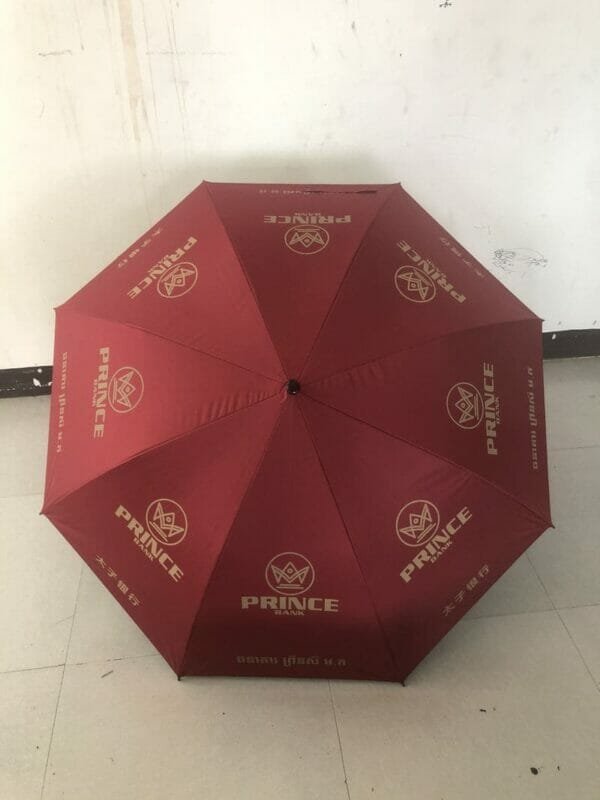 A 30in Black Single Layer Auto Golf Umbrella with a gold logo on it.