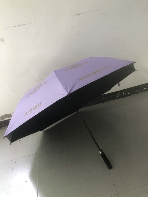 A 30in Black Single Layer Auto Golf Umbrella with black writing on it.