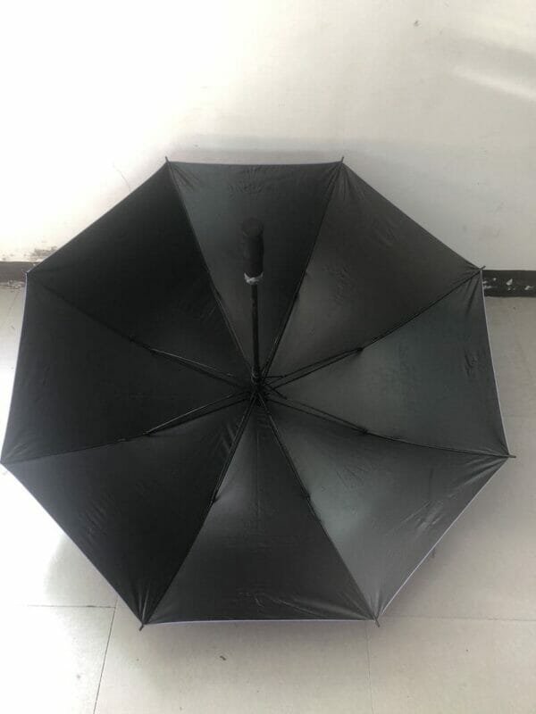 A 30in Black Single Layer Auto Golf Umbrella sitting on a white floor.