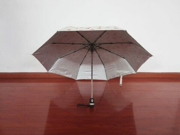 an umbrella sitting on top of a wooden table