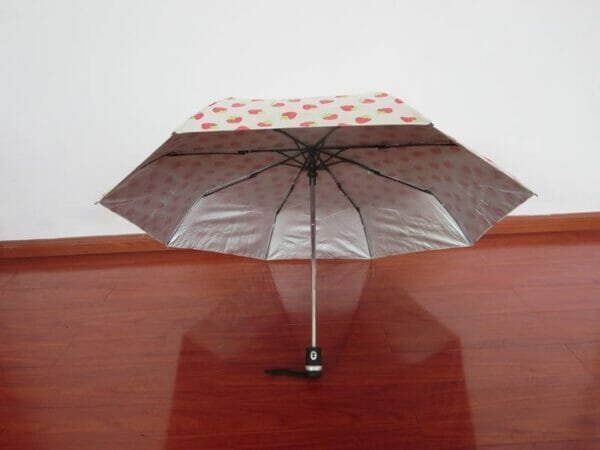 an umbrella sitting on top of a wooden table