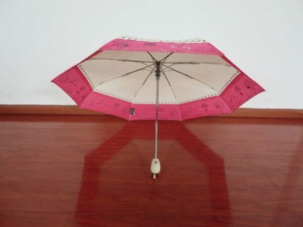 an umbrella sitting on top of a wooden table