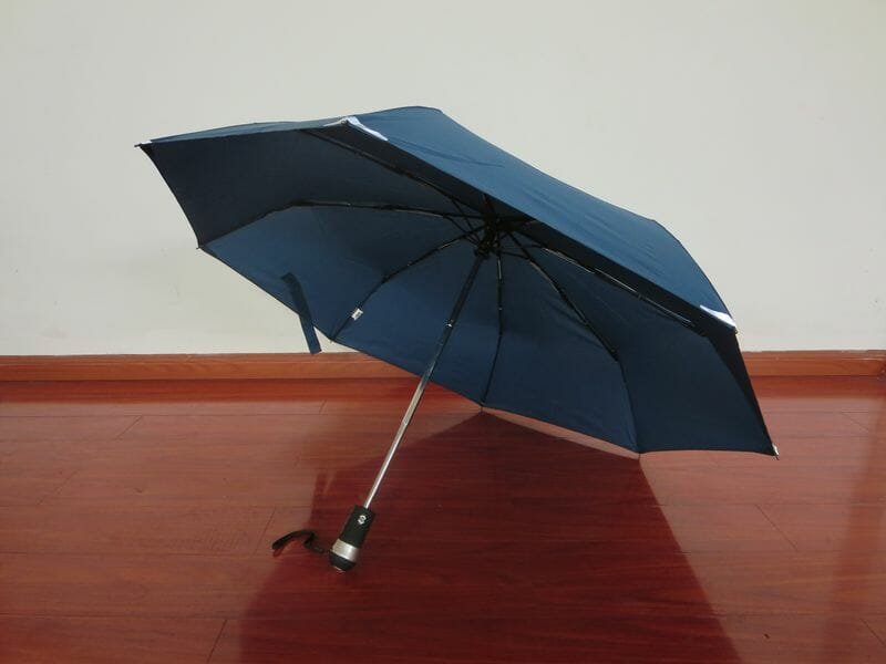 an umbrella sitting on top of a wooden table