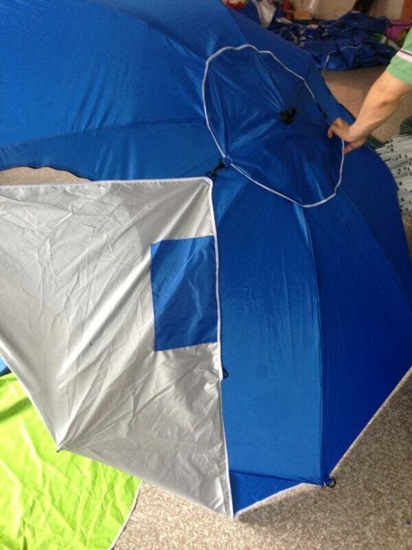 a hand holding a blue umbrella