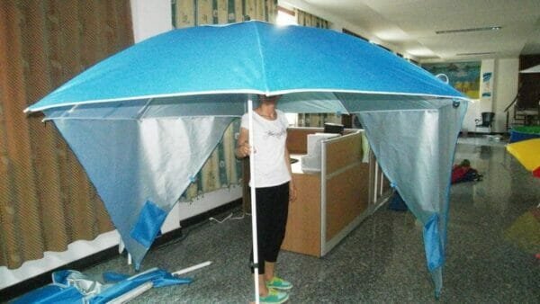 a person holding a blue umbrella