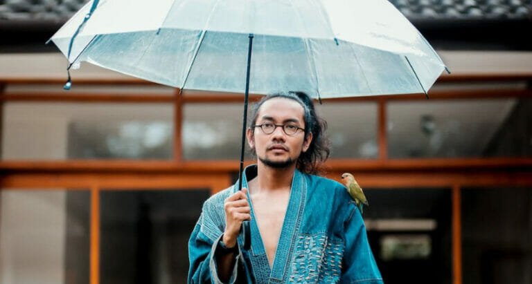 a woman holding a blue umbrella